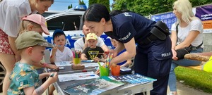 Policjanci i dzieci na stoisku policyjnym