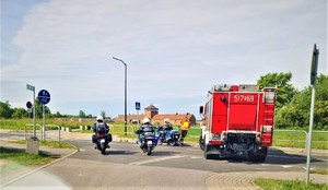 Policjanci i strażacy zabezpieczają rajd rowerowy w tle Brama Śmierci