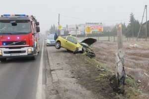 Na zdjęciu ulica, rozbity samochód oraz Straż Pożarna