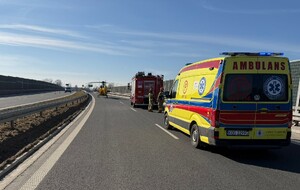 Służby ratunkowe na ulicy obok uszkodzony motocykl