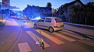 Miejsce potrącenia rowerzystki. Rower , samochód i radiowóz na ulicy.