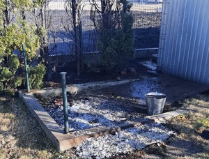 Na zdjęciu widać ogrodzenie posesji oraz miejsce po spalaniu odpadów